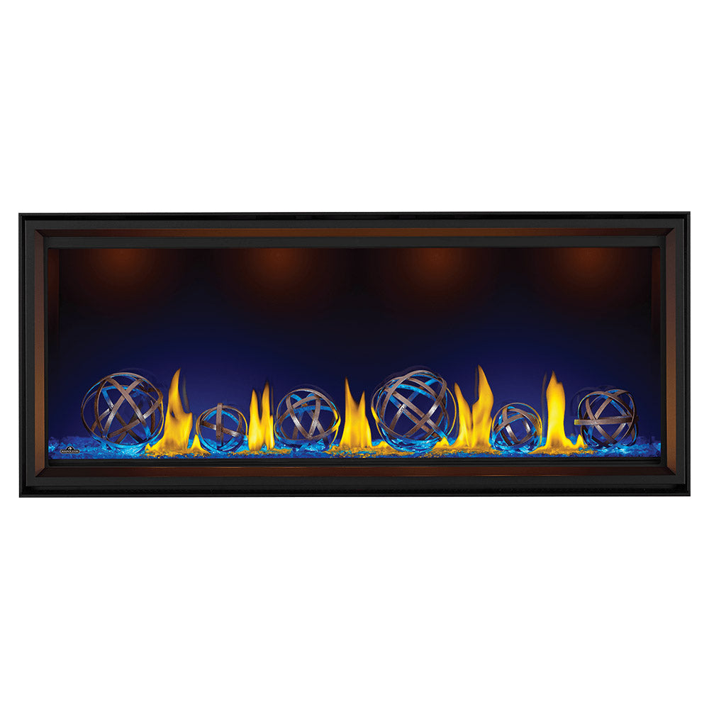 Black linear gas fireplace with burning logs, blue-toned ember bed, and globe decor