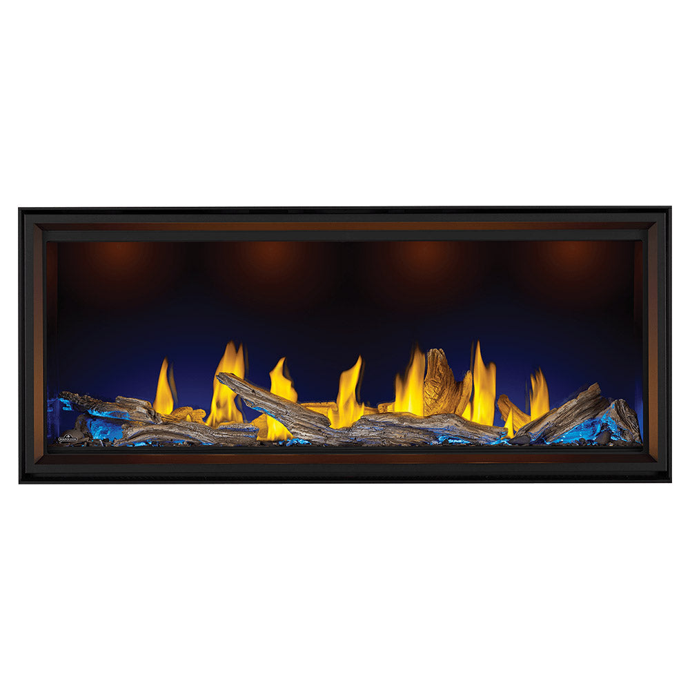 Black linear gas fireplace showing flames over dark rock and blue-toned embers