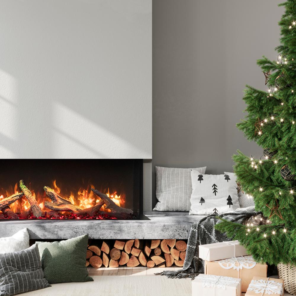 Built-in electric fireplace showing flames and log bed with nearby holiday decor
