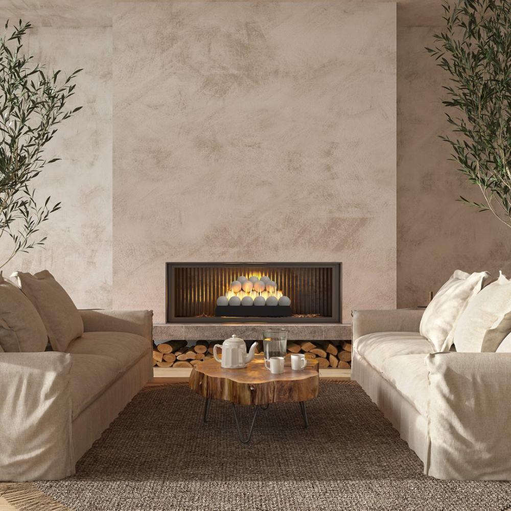 Ventless fireplace burner with glowing Fyre spheres and orange flames in surround