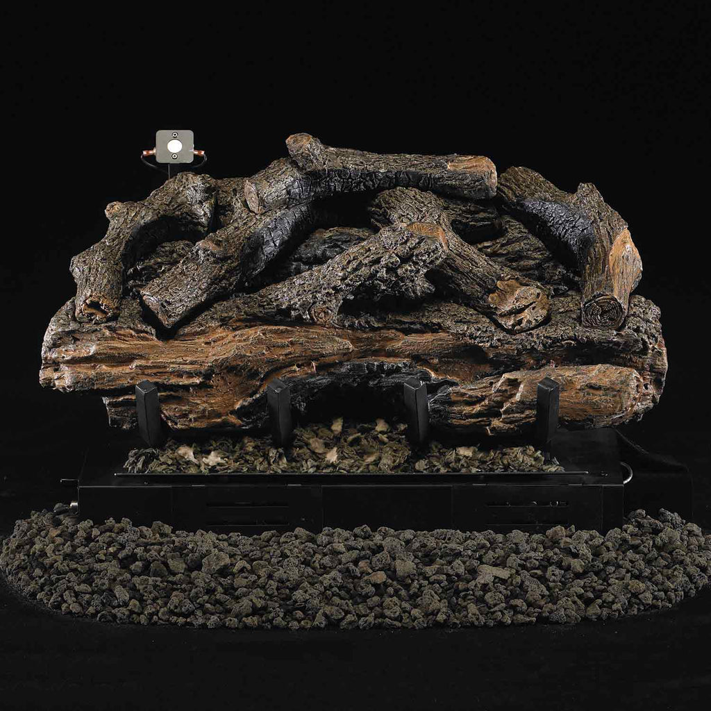 Charred aged ventless gas log set with dark logs and black base, no visible flames