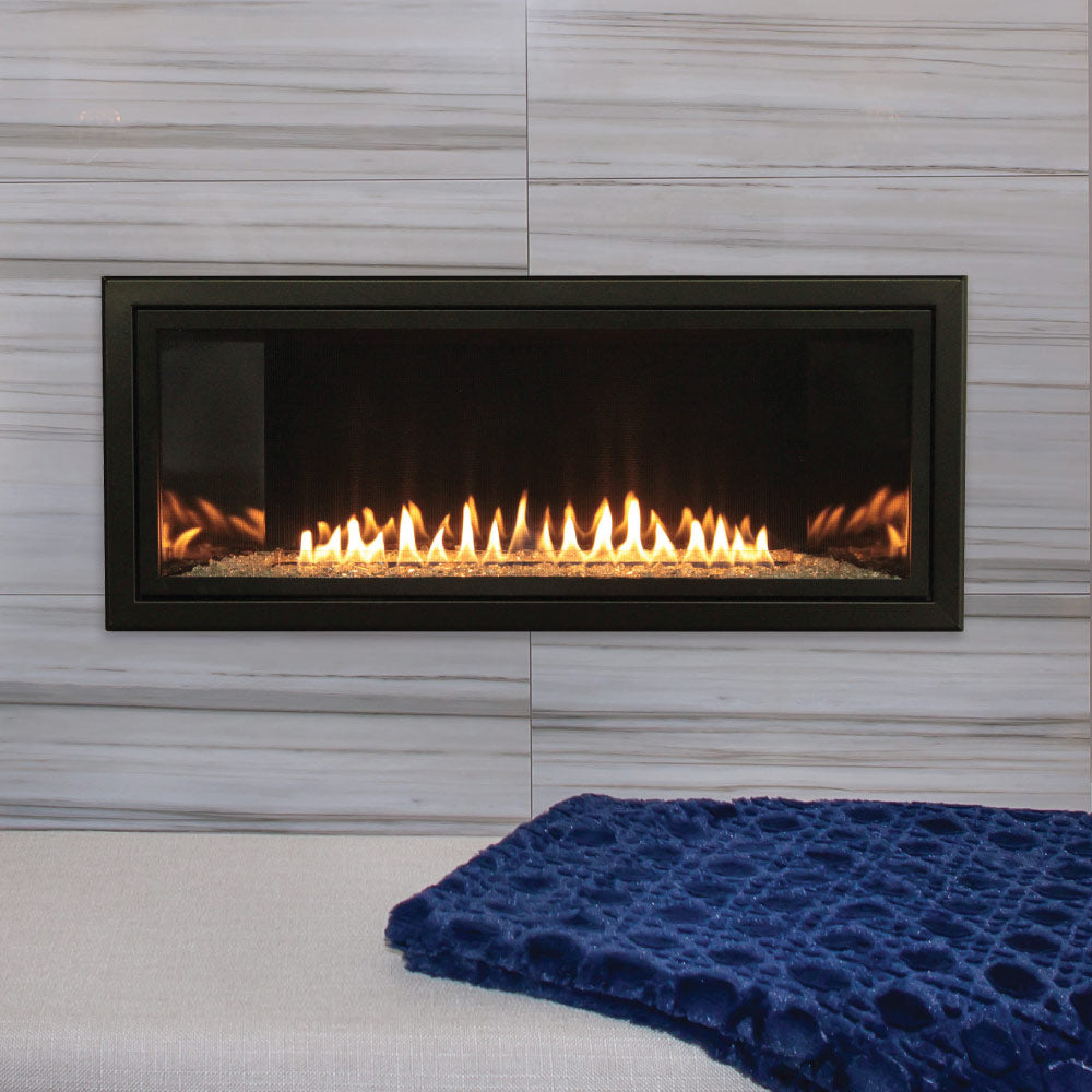 Ventless linear fireplace with dark metal frame and visible flame in a long firebox