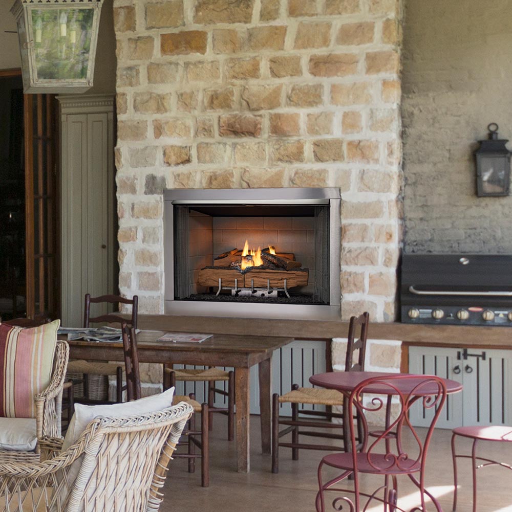 Outdoor gas fireplace with firebox showing glowing wood logs and blue-gray burner base