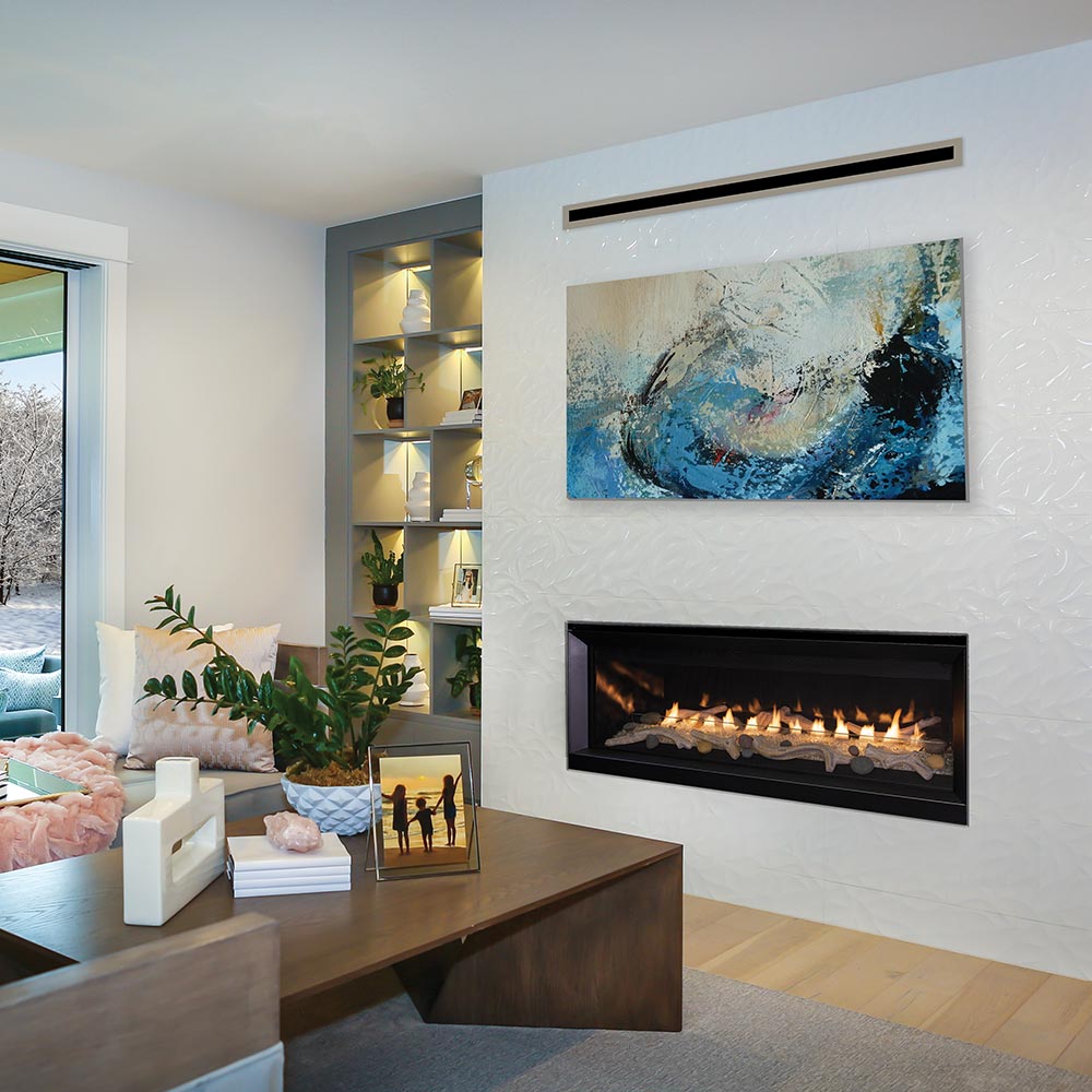 Recessed vent-free gas fireplace with burning flames and gray crushed glass in black frame