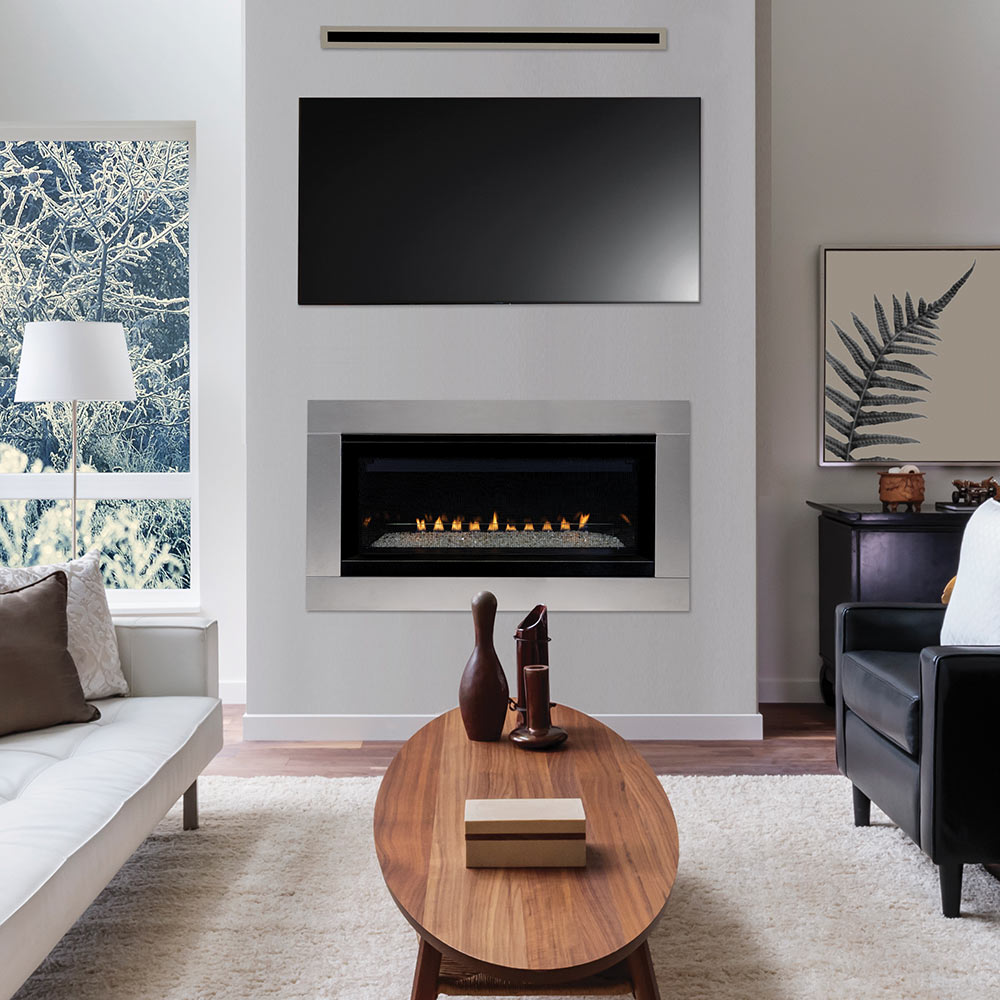 Built-in vent-free gas fireplace insert with lit flames in a black surround