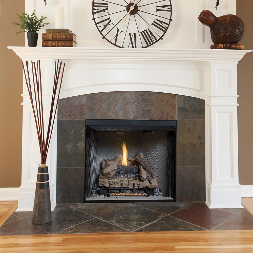 Indoor fireplace insert with black firebox opening and burning logs in stone surround
