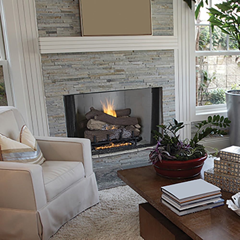 Built-in gas log fireplace with burning logs and black surround