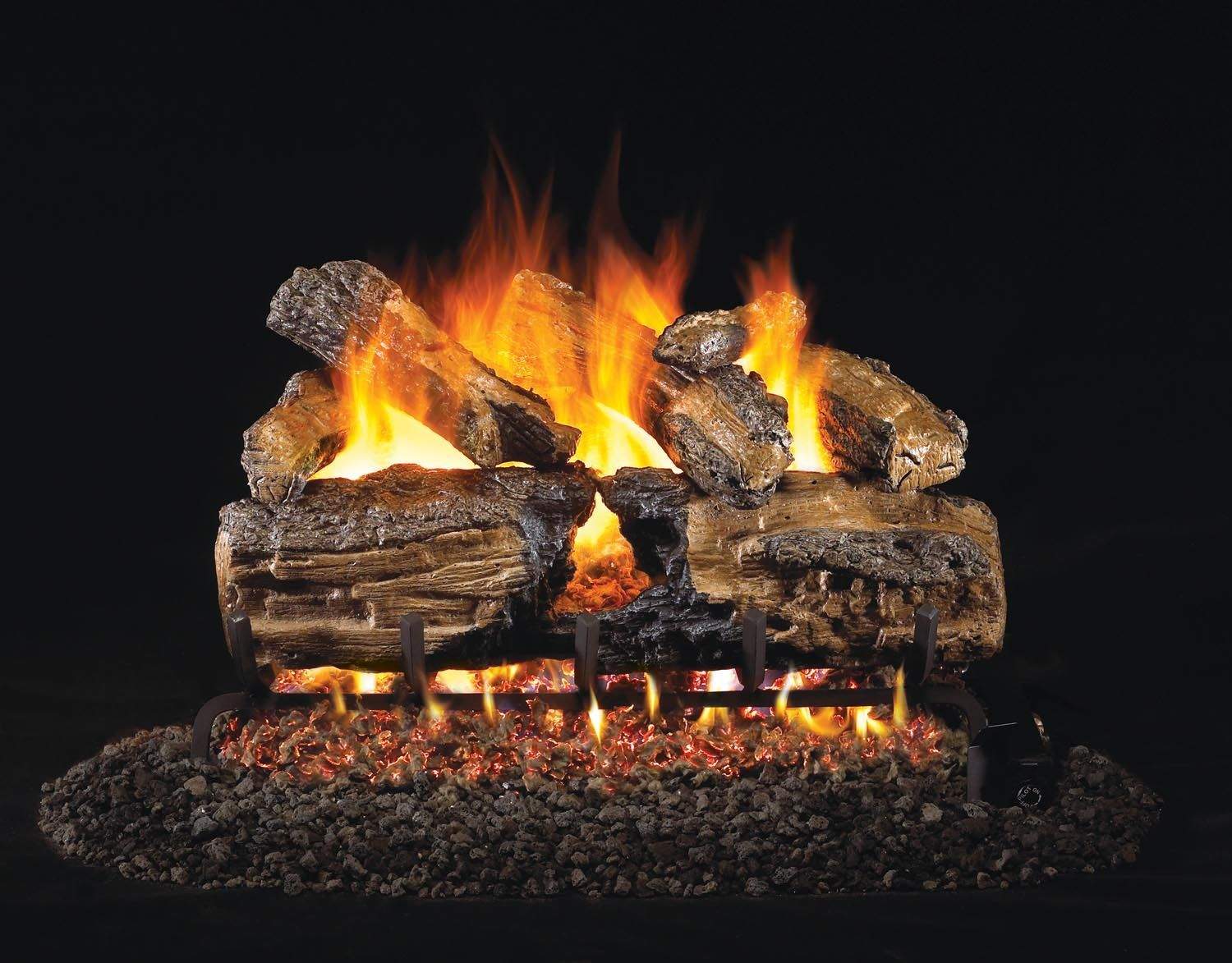 Burnt split oak gas logs burning with bright orange flames and charred logs