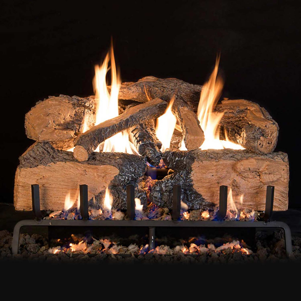 Vented gas log set with charred oak split logs and burning flames