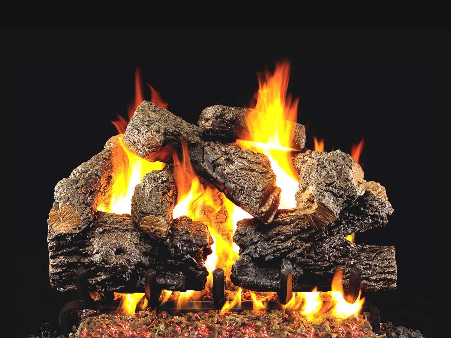 Vented gas log set with charred oak logs and active yellow flames