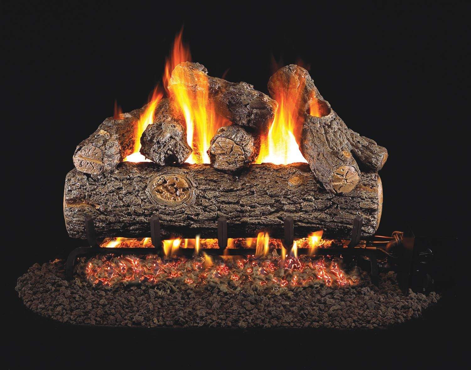 Vented gas log set with glowing logs and open flames on a burner base