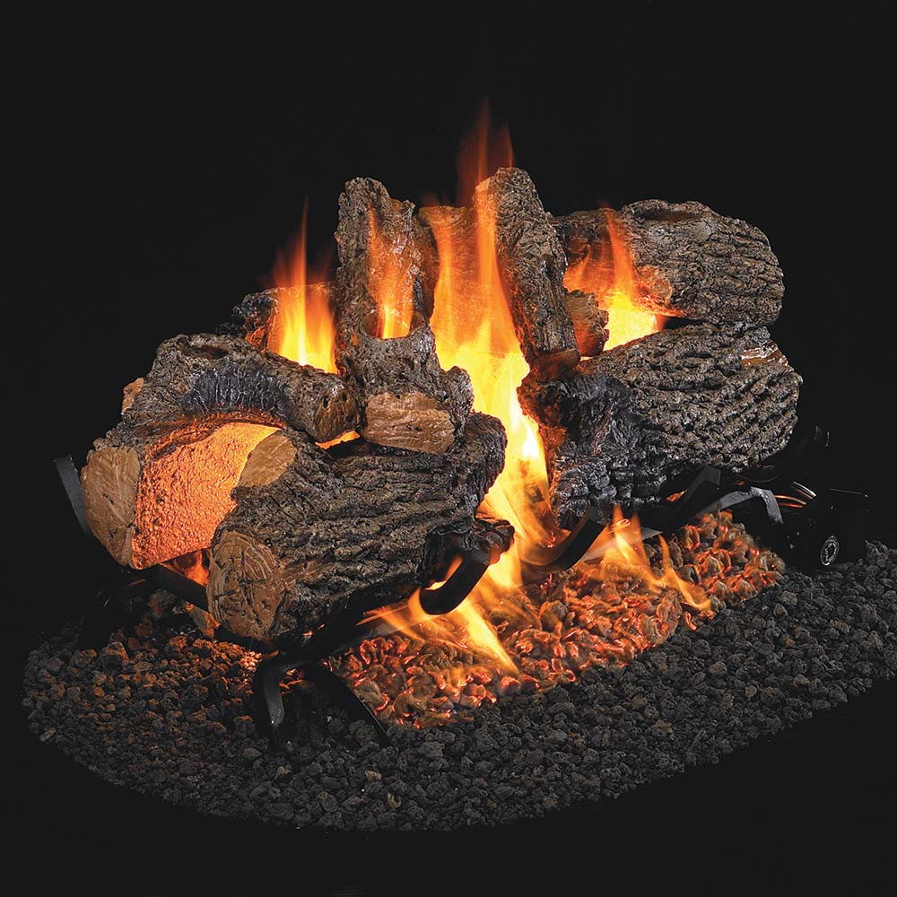 Vented gas log set with charred oak logs and glowing flames in a burner bed