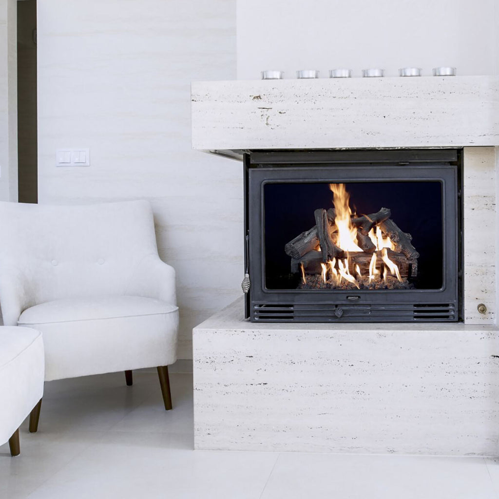 Vented gas log set in a fireplace with driftwood-style logs burning