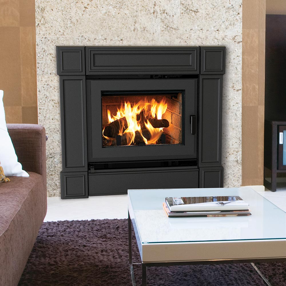 Black freestanding wood-burning fireplace with glass door showing burning logs