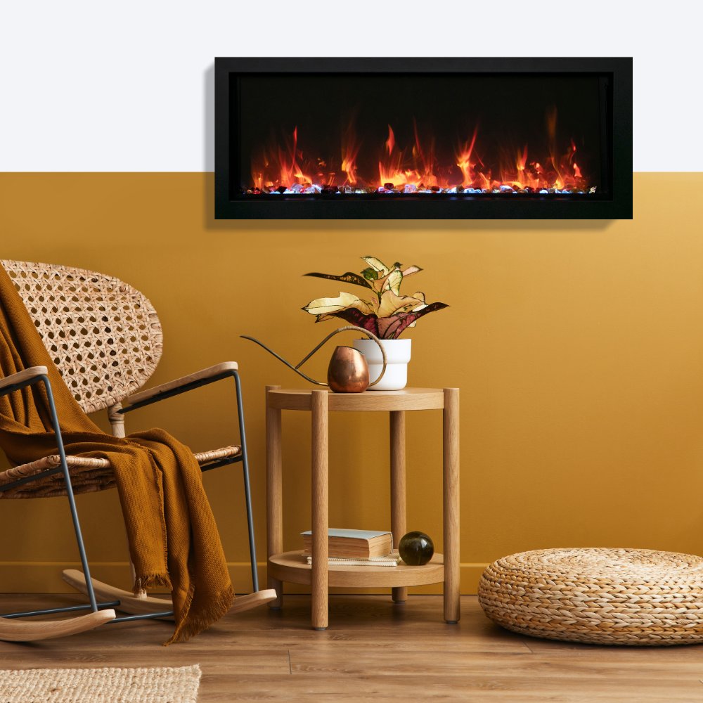 Wall-mounted slim electric fireplace with orange flames behind a dark glass frame