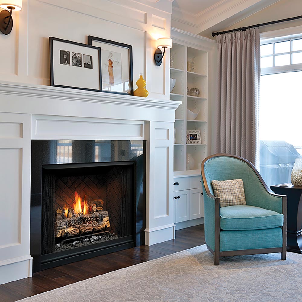 Black vent-free gas firebox with log set and burning flames behind the mesh screen
