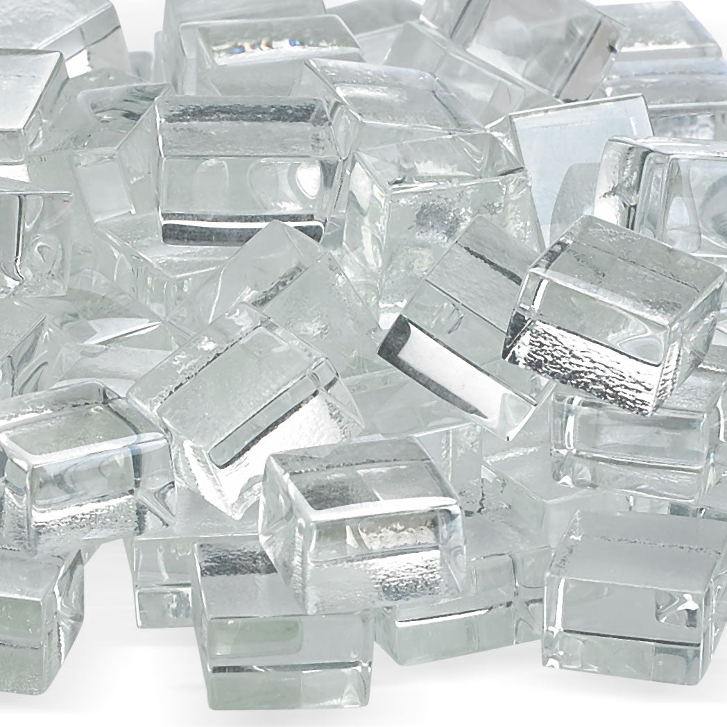 Clear fire glass cubes, close-up with reflective tops and faceted edges for fire pits