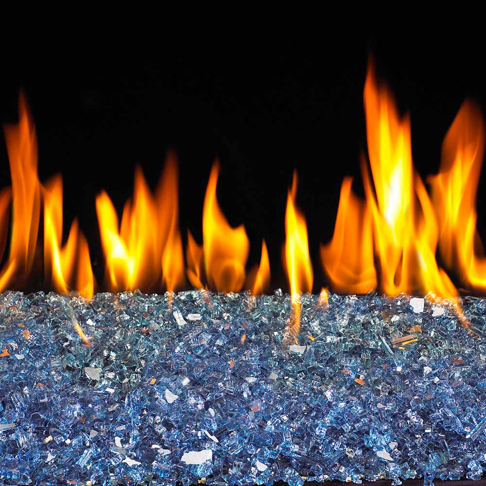 Caribbean blue fire glass bed with tall flames in fireplace