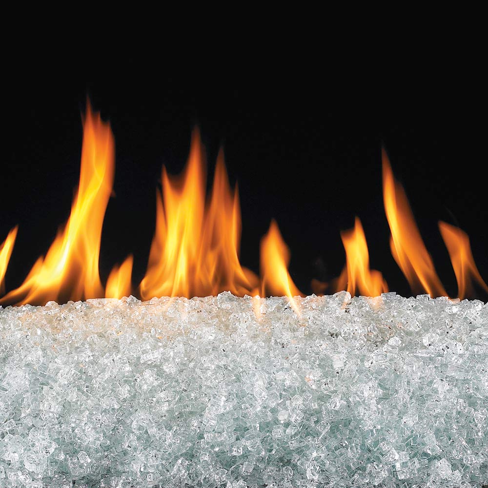 Clear fire glass bed with bright flames rising in a fire pit