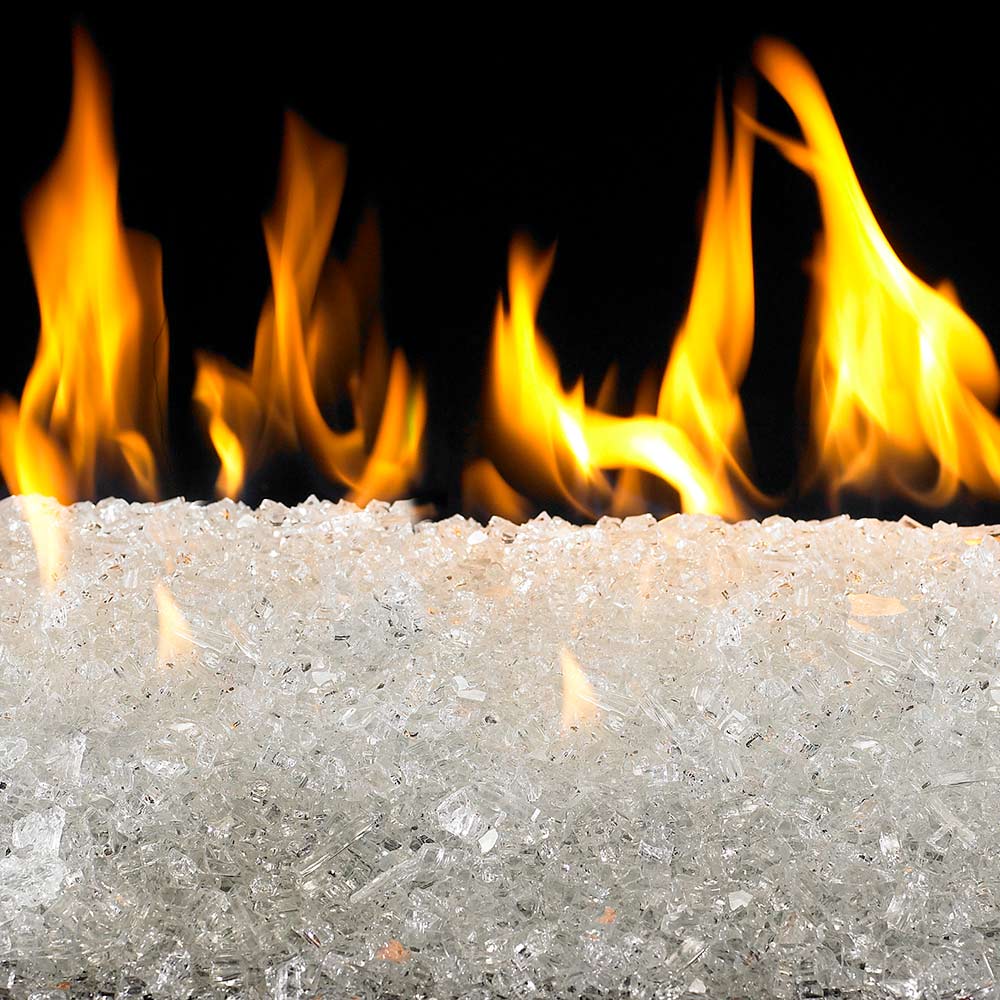 Clear fire glass stones for a fire pit, with visible flames behind