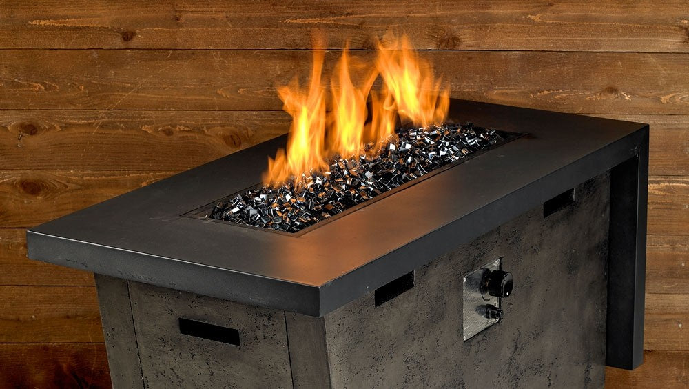 Black luster fire glass bed in a fire pit, with flames