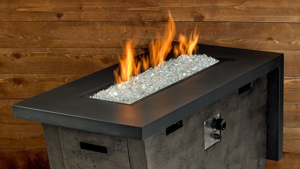 Fire pit with clear fire glass bed, flame burning above
