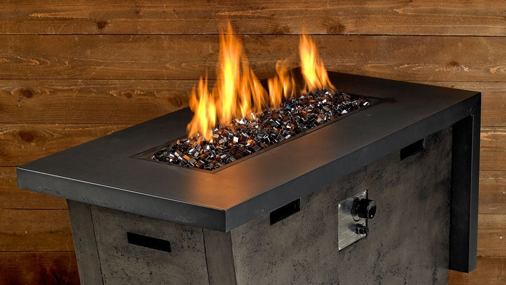 Fire pit with copper luster fire glass bed and flames rising