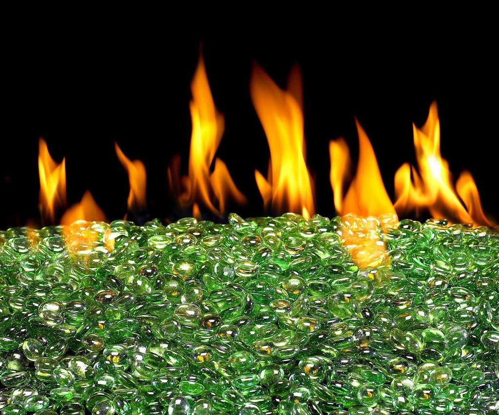 Emerald green fire glass gems, small round glass pebbles scattered on a surface