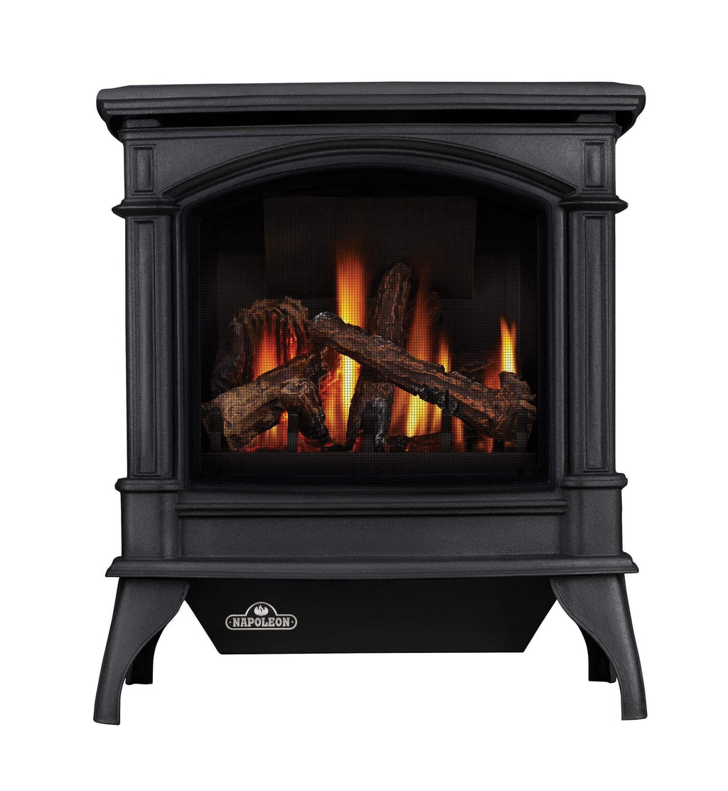 Black cast iron gas stove with arched glass firebox and burning logs