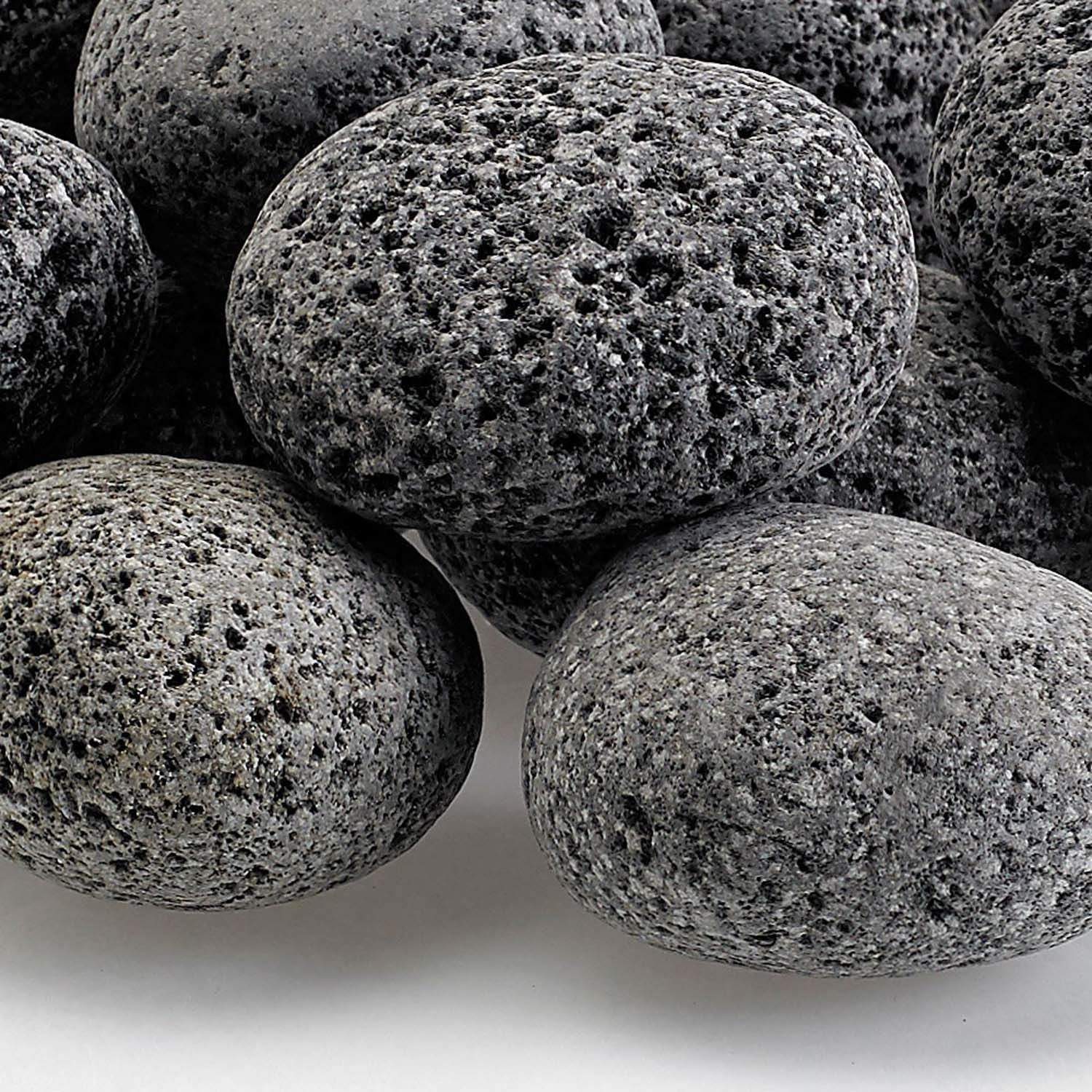 Gray lava stone rock close-up, rough pitted surface with dark speckles