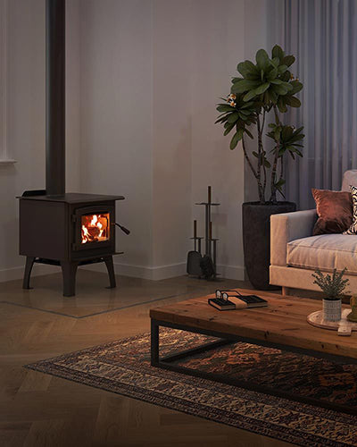 Black freestanding wood stove with glass door and visible flames