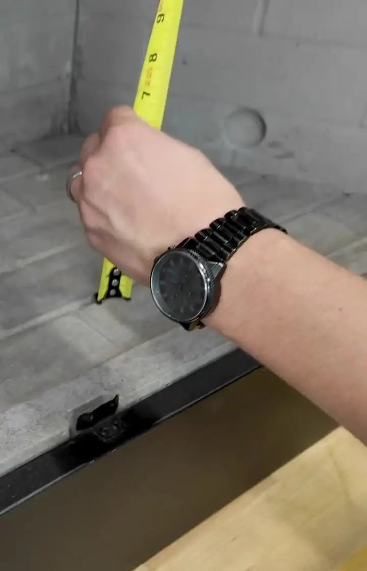 Fireplace Technician measuring a fireplace for gas log installation