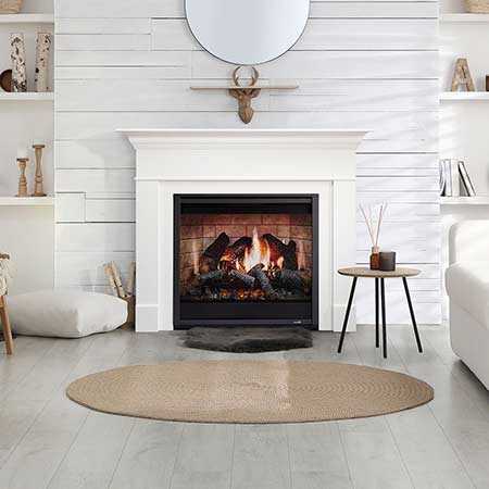 White electric fireplace mantel with flame display behind glass front