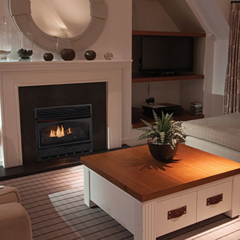 Vent-free gas fireplace with ceramic fiber logs, glass front showing burning flames